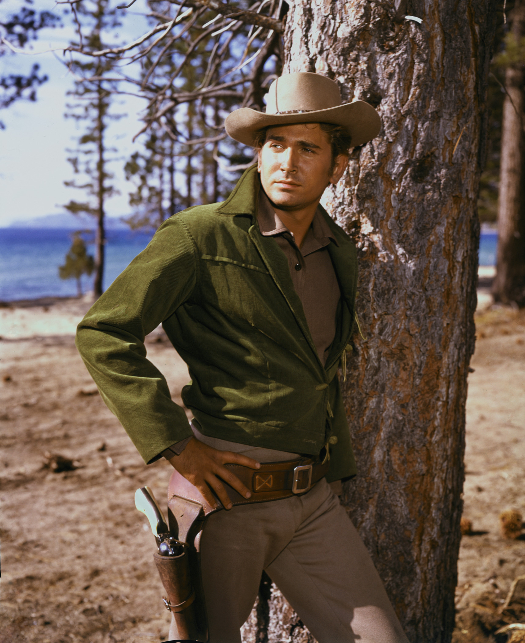 Michael Landon leaning up against a tree in Bonanza. --- Image by © Bettmann/CORBIS