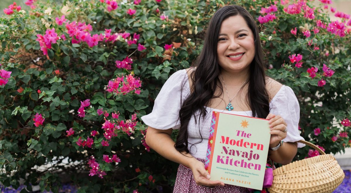 Alana Yazzie (The Fancy Navajo) holding her new cookbook, The Modern Navajo Kitchen