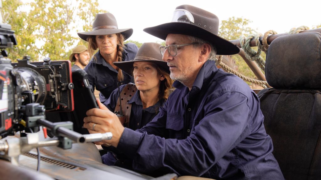 Greg McLean views footage on the "Territory" set.